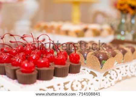Horizontal picture of beautiful chocolates with cherry and truffles for woman party