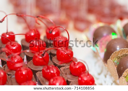 Macro picture of delicious dessert made  with chocolates with cherry for woman party