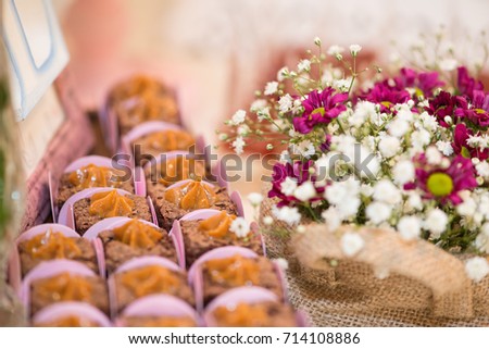 Close up picture of  milk candy dessert and colorful flowers for woman party