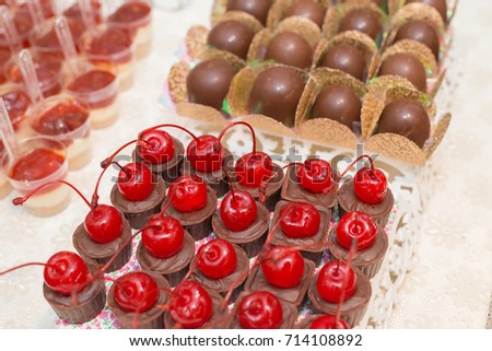 Macro picture of delicious dessert made  with chocolates with cherry and truffles for woman party
