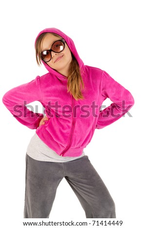 Funky young girl in pink tracksuit posing isolated on white background