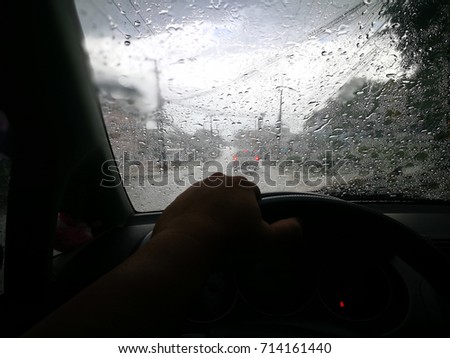 Drive a car in a rainy and drops on windshield