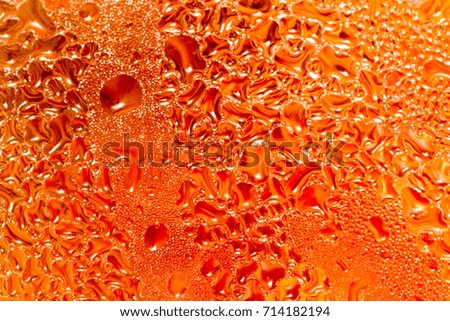 abstract background of drops on a red glass
