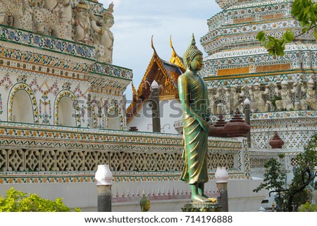 Golden buddha statue from side meditating at Wat Arun or Temple of Dawn in Bangkok, Thailand.