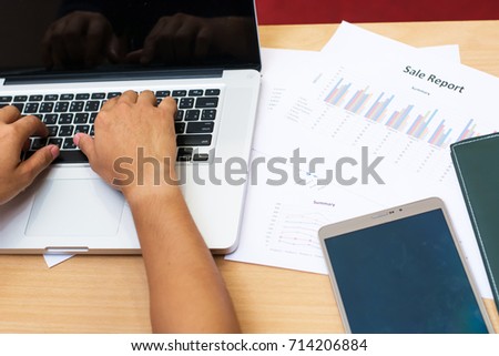 Business man working at office with phone.tablet and graph data 