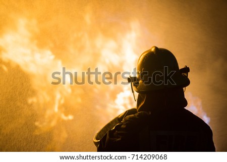 firefighter with fire background