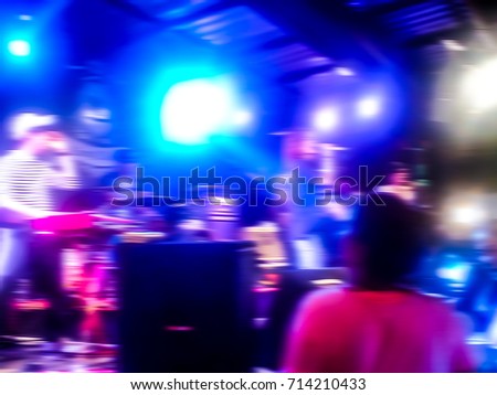 The live music scene of the pop band is very popular with the audience. Concert pictures at night time. Abstract photo blur