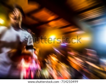 The live music scene of the pop band is very popular with the audience. Concert pictures at night time. Abstract photo blur