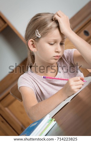 Girl studying or doing homework, feeling tired and bored
