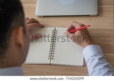 Close up of businessman hand taking notes on a notebook at a business meeting for personal reference, while meeting minutes are for official record-keeping purposes.
 Royalty-Free Stock Photo #714224299