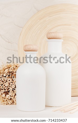 Blank white cosmetics bottles on white wood board. Template for advertising, designers, branding identity, cover.