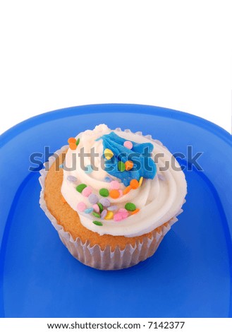 Decorated Vanilla Cupcake On A Blue Plastic Plate, With Copy Space Isolated Over White
