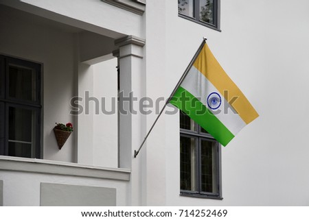 India flag. Indian flag displaying on a pole in front of the house. National flag of India waving on a home hanging from a pole on a front door of a building.