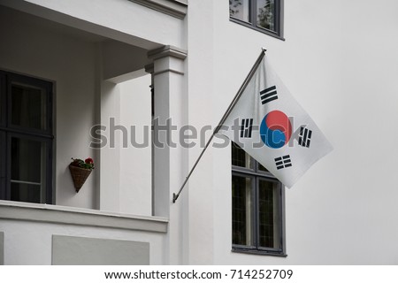South Korea flag. Korean flag displaying on a pole in front of the house. National flag of South Korea waving on a home hanging from a pole on a front door of a building.