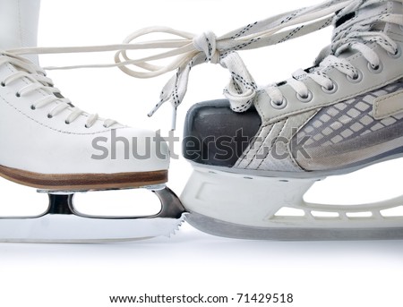  Skate for figure skating and  hockey skate tied against each other close up isolated on white background