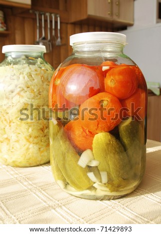Glass jar with tinned vegetables on a table