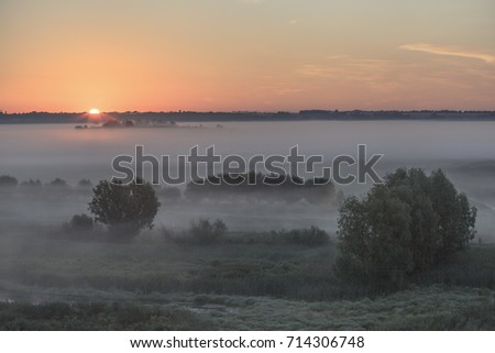 sunrise over a misty autumn meadow

