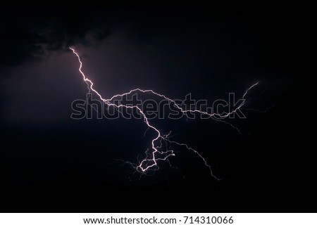 Lightning in the night sky. The concept of bad weather, storms and heavy rain. The power and fascinating beauty of nature