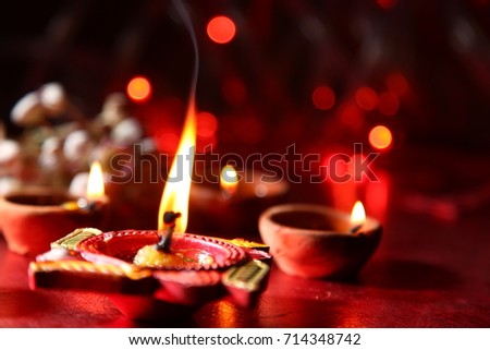 Diwali greetings, Diya lighting  Royalty-Free Stock Photo #714348742
