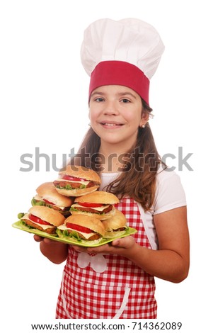 little girl cook with hamburgers on plate