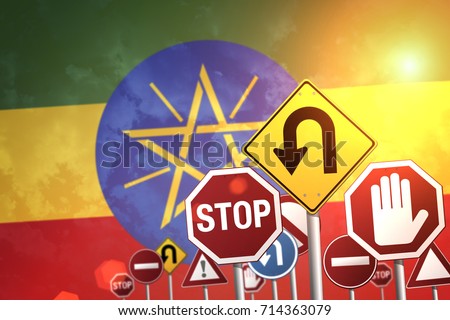 Road stop signs on a background of Ethiopia flag