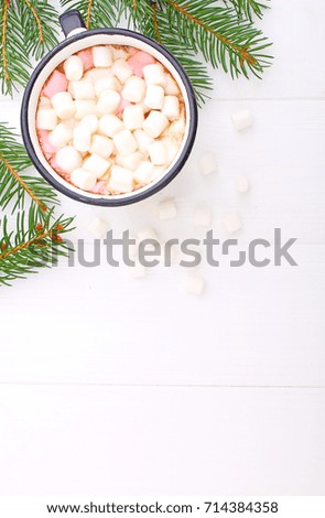 A cup with cocoa and marshmallow on a white background, spruce branches, copy space.