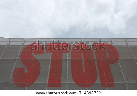 Stop sign on a metal curtain wall.
