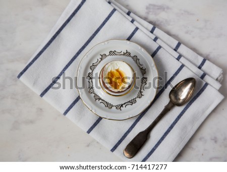 Served Table Boiled Egg on Support Teaspoon White Crumpled Striped Napkin on Grey Marble Background Top View
