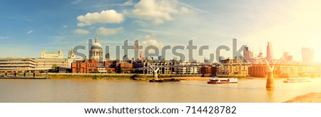 London, panoramic view of passenger ships passing Millennium bridge and St. Paul on a bright sunny day. Toned image.