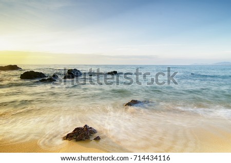 Travel And vacation concept background, beautiful tropical beach sunrise sea view. soft wave hitting sandy beach