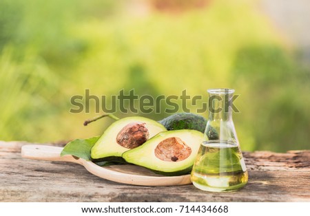 Close up avocado in a tray and oil in a glass jar