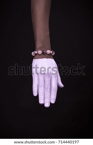 one woman hand, african american painted hand skin, black background, jewelery bracelet