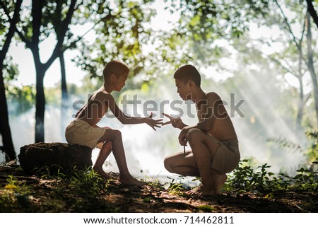 couple boy playing battle symbol hand native of thailand.Lifestyle Countryside 