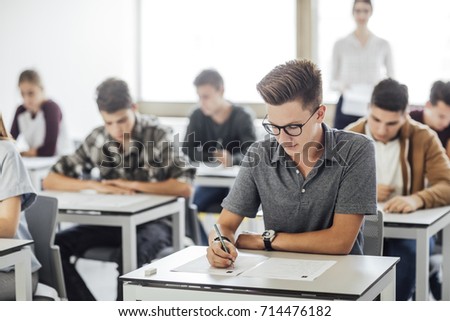 Group of high school students having test at classroom. Royalty-Free Stock Photo #714476182