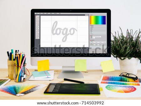  Stationery desktop with design stuff, computer and graphic tablet. Logo design.