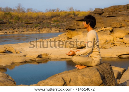 Asian man has meditation at Sam Phan Bok beside Mekong river.