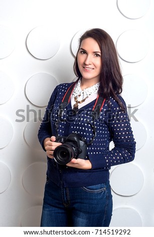 studio portrait of young woman taking picture over white