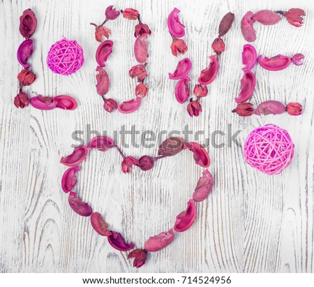 Word love flowers on white wooden background isolation