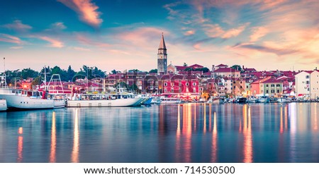 Great summer sunset in port of old fishing town Izola. Colorful spring evening on Adriatic Sea. Beautiful seascape of Slovenia, Europe. Traveling concept background.
