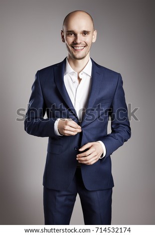 Portrait of smiling handsome young businessman in suit. 