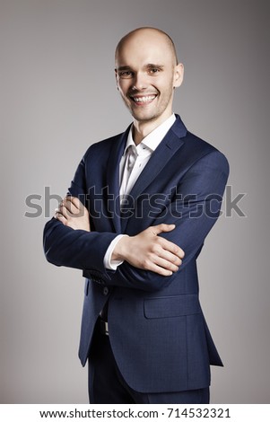 Portrait of Smiling Businessman with Arms Crossed. 