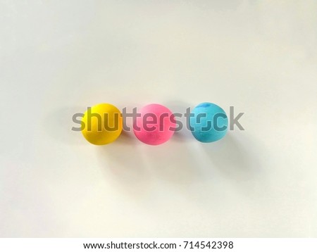 Multicolored plasticine clay (sweet pastel color) are flat sphere placed on a white background