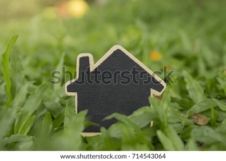 real estate investment ,image of house model on green grass,for sale or rent property