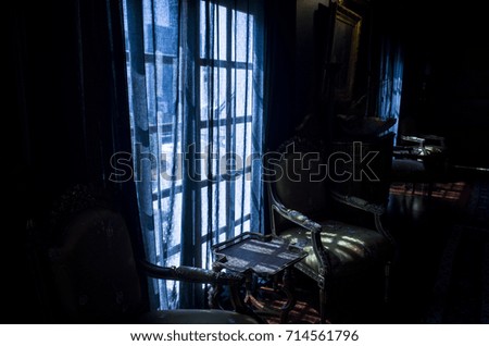 armchair and curtain at the window 