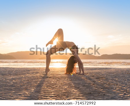 Young Girl Practicing Yoga On Beach At Sunset, Beautiful Woman Summer Vacation Meditation Seaside Sea Ocean Holiday Travel