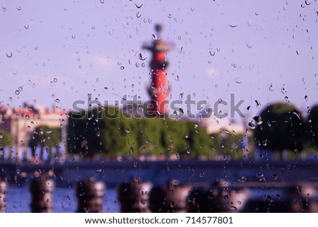 city night landscape through wet glass. Rain drops on window. Peaceful raining outside. Water drops on glass. Surface of wet glass. Water splash. City lights bokeh during the rain river and lanterns