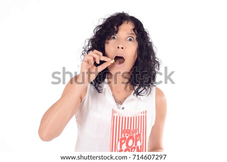 Portrait of beautiful woman eating popcorn and watching movies. Isolated white background.