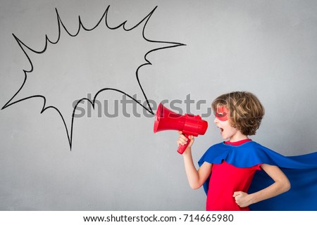 Child pretend to be superhero. Super hero kid playing at home. Imagination and winner concept