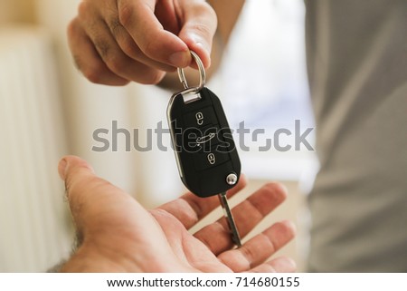 Hand of business man gives the car key Royalty-Free Stock Photo #714680155