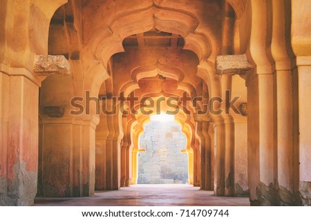 Old ruined arch of Lotus Mahal at sunset, Hampi, Karnataka, India. Royalty-Free Stock Photo #714709744